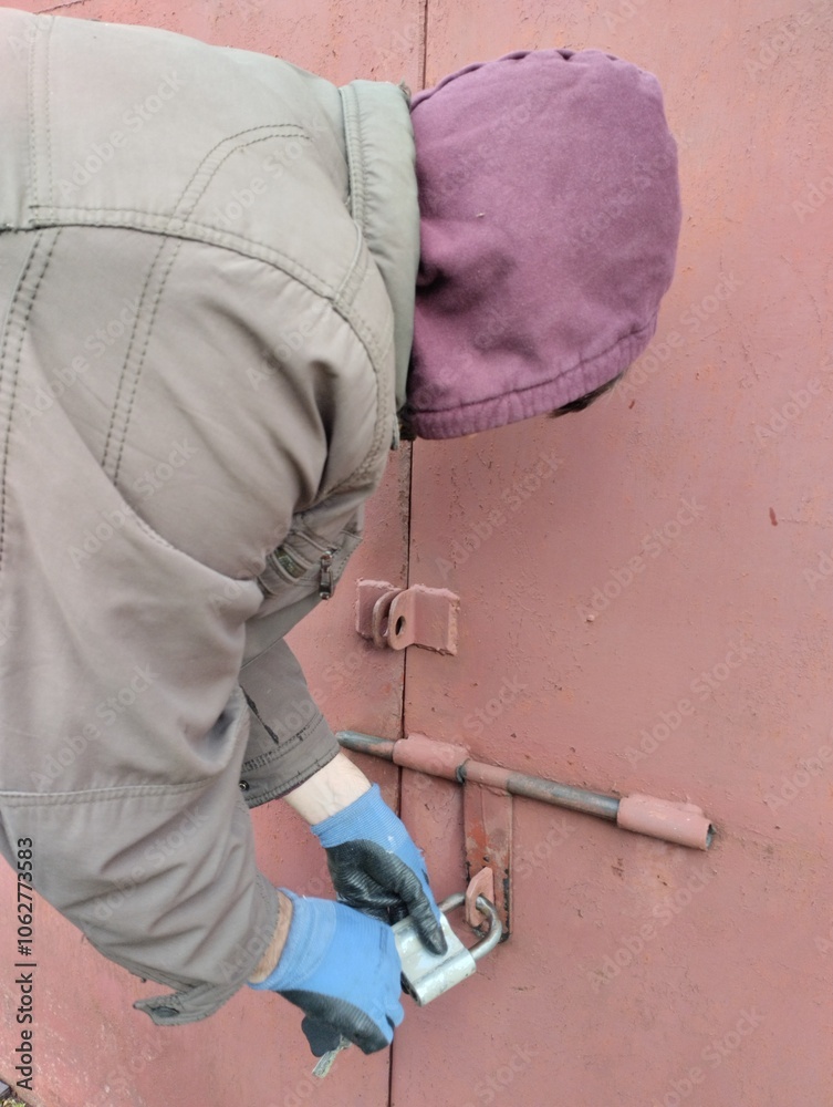 burglar, thief trying to open the lock, thief robs house