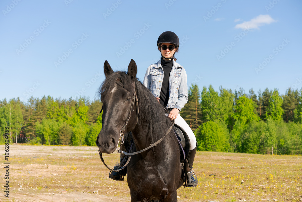 Woman is riding a horse in a field Woman is riding a horse in a field