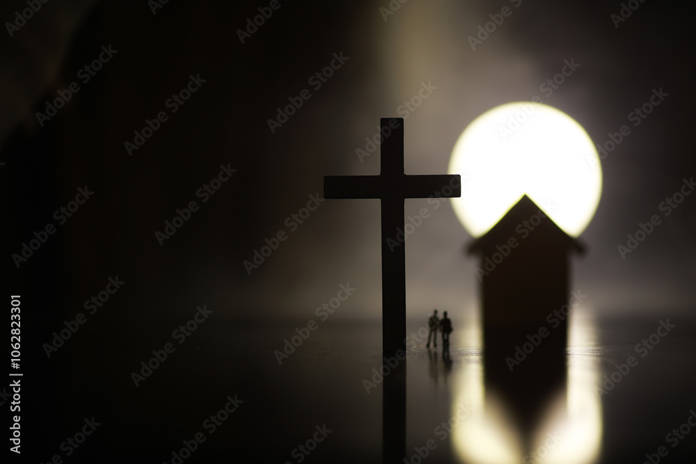 Naklejka premium Silhouetted Figures near Cross and House at Sunset - Spirituality and Home Concept Image