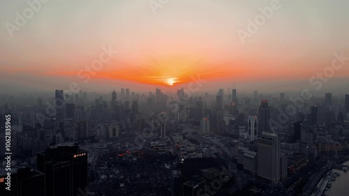 Aerial footage of the urban skyline of Shanghai city with asunset scene in the background, China photo