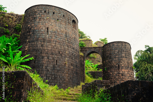 Yashwantgad Fort in Redi, Maharashtra, near the Maharashtra-Goa border. Green roots of trees grows on the old walls