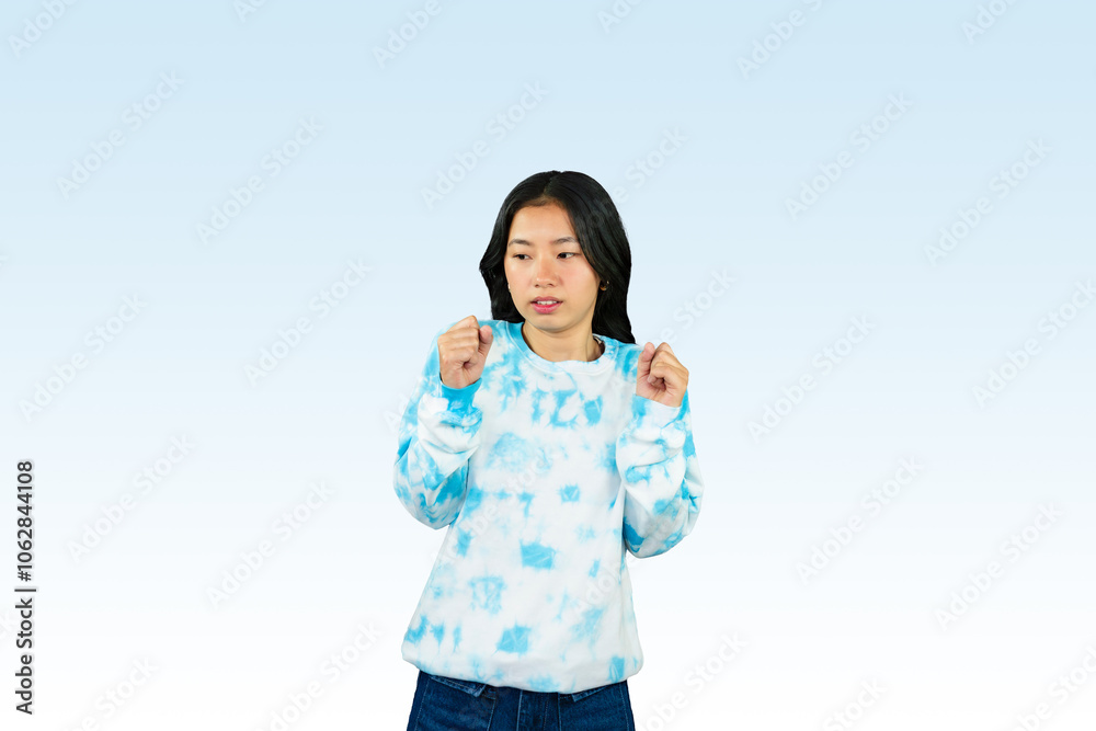 Yougn Asian girl with blue dress points and gives various expression and gestures isolated happy sad Yougn Asian girl with blue dress points and gives various expression and gestures isolated happy sad