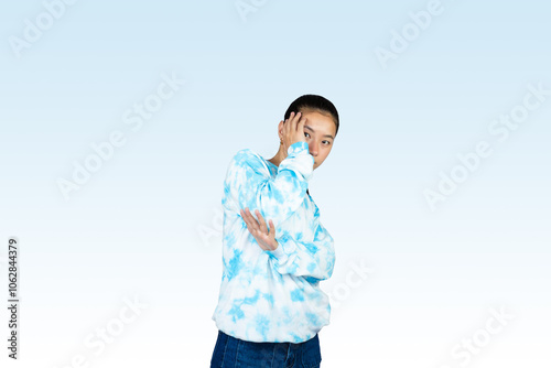 Yougn Asian girl with blue dress points and gives various expression and gestures isolated happy sad photo