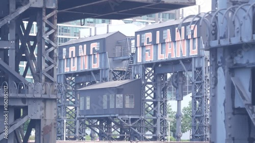 New York City Gantry Plaza dock pier, Long Island sign, Hunters Point, Queens, United States. Industrial waterfront iron vintage landmark, historic old riverfront gantry, East River opposite Manhattan