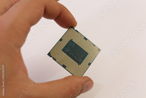 hand holding computer processor in isolated hand