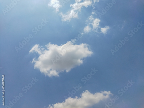 clouds in a clear sky with high sunlight