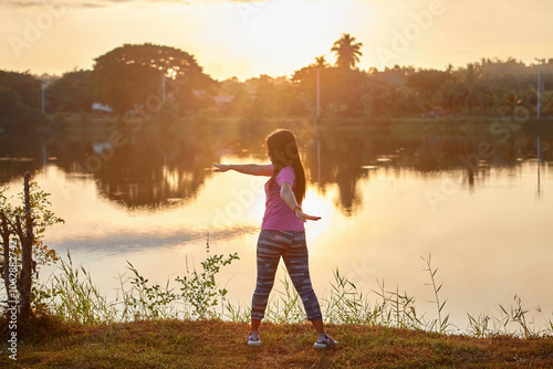 Asian woman exercising during sunset