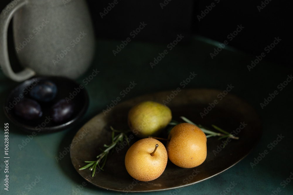 Artistic still life with pears, rosemary, plums, and a ceramic pitcher Artistic still life with pears, rosemary, plums, and a ceramic pitcher