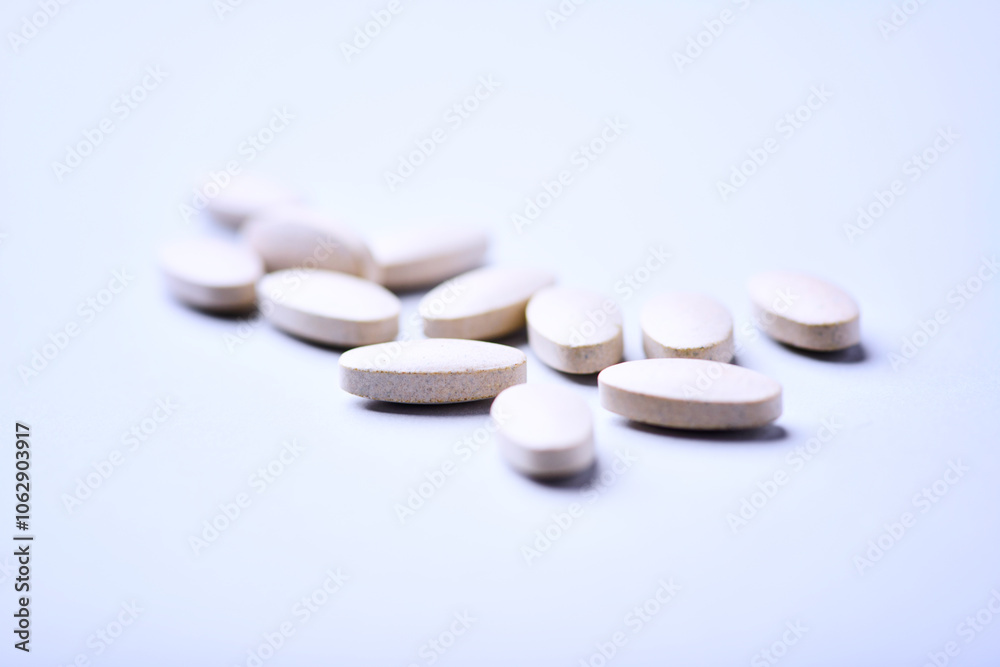 Ashwagandha (Withania somnifera) tablets. Concept for a healthy dietary supplementation. Bright paper background. Close up. Copy space.
