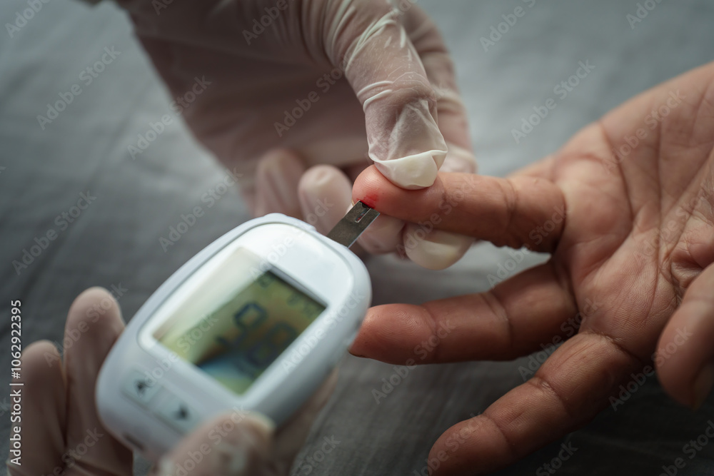 doctor using glucometer checking blood sugar level of senior woman. diabetes concept doctor using glucometer checking blood sugar level of senior woman. diabetes concept
