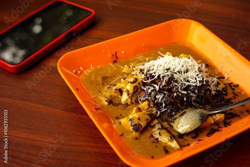 Pisang Gapit (Roasted Banana) is a typical Banjarmasin food, this food consists of bananas that are clamped, served with peanut sauce, chocolate and cheese. photo