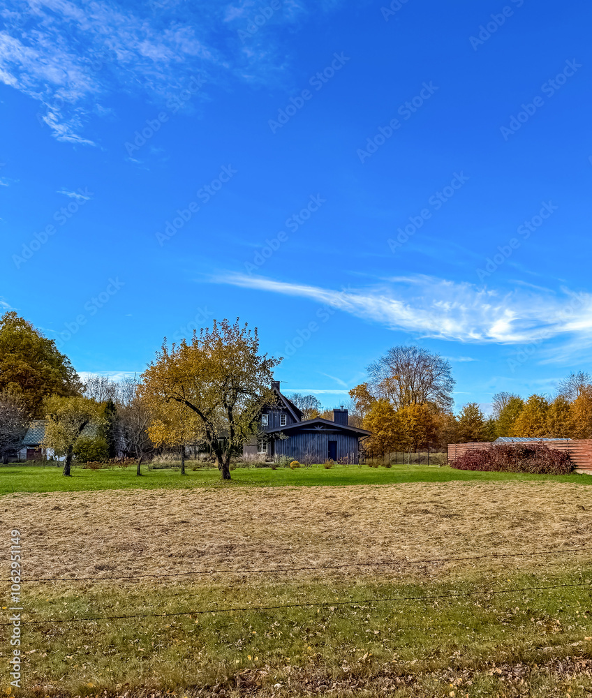 Autumn Countryside with Blue Sky and Rustic House. High quality photo