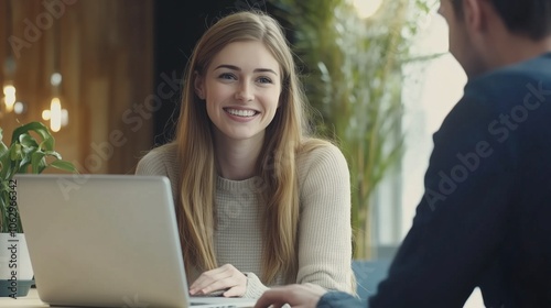 Happy young employee woman talking to male coworker.