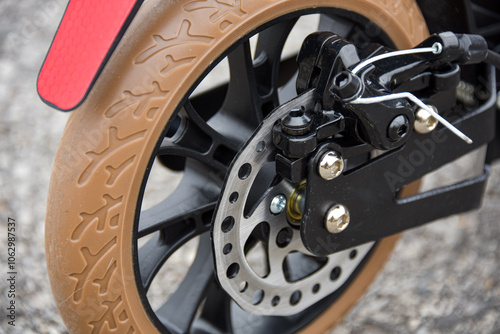 Disc brake on the rear wheel of a scooter. Close-up.