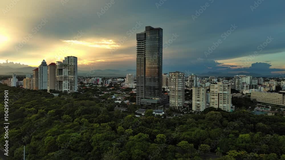 Anacaona 27 tower skyscraper and Mirador Sur Park. Santo Domingo in Dominican Republic. Aerial forward Anacaona 27 tower skyscraper and Mirador Sur Park. Santo Domingo in Dominican Republic. Aerial forward