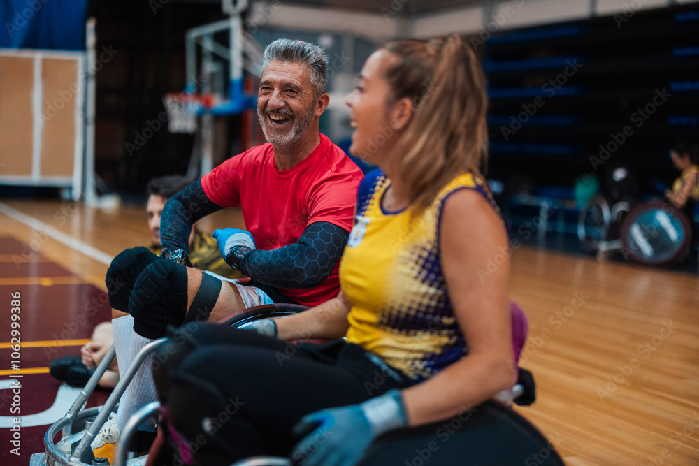 Happy athletes sitting on wheelchairs at sports court Happy athletes sitting on wheelchairs at sports court