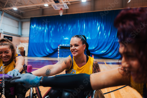 Happy disabled players stacking hands together photo