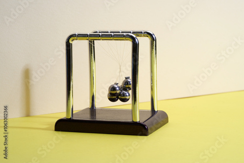 Newton's Cradle desk toy with tangled balls.