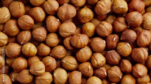 Hazelnuts rotating. Organic snack. Pile of hazelnuts without shell. Vegan food. Top view. Healthy nutrition. Peeled brown nut. Hazelnut kernels rotating. Slider dolly shot. Zoom out. 4K, UHD