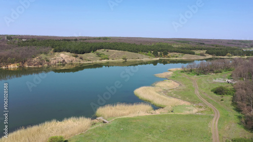 Wallpaper Mural Rural scene in the spring. Lake, country road and forest aerial view Torontodigital.ca