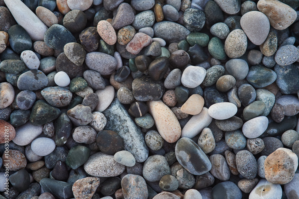 A close-up of a collection of smooth, multicolored pebbles and stones. These natural beach rocks display a variety of earthy tones and textures, creating a calming and organic aesthetic. A close-up of a collection of smooth, multicolored pebbles and stones. These natural beach rocks display a variety of earthy tones and textures, creating a calming and organic aesthetic.