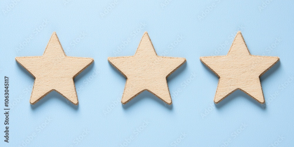 Three wooden stars on a light blue background. Three wooden stars on a light blue background.