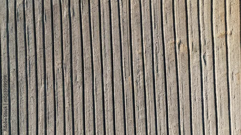 Brown earth top view. Striped pattern of ploughed farmland soil. top view aerial shot top down Brown earth top view. Striped pattern of ploughed farmland soil. top view aerial shot top down