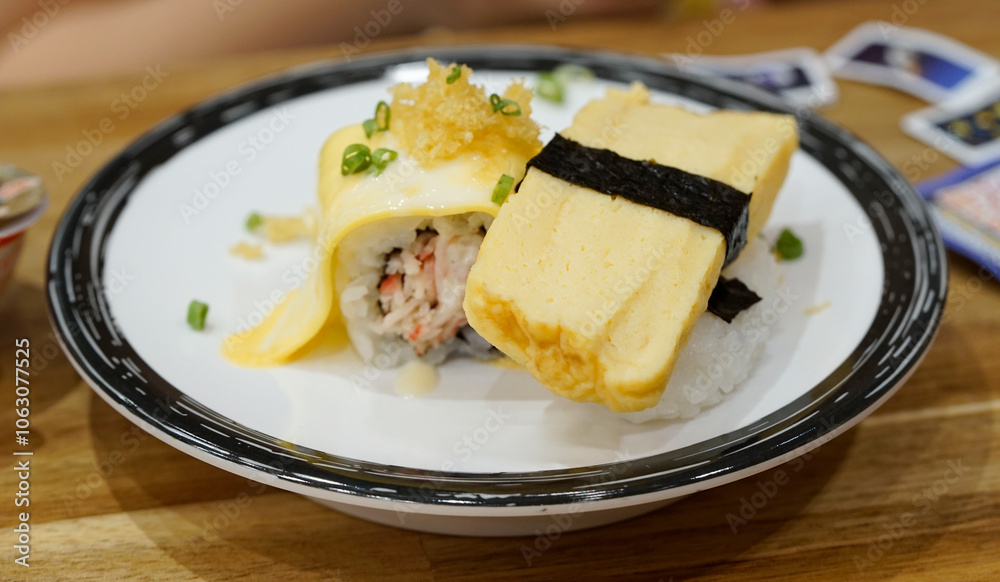 Japanese food - Tamago egg nigiri isolated on white dish. Japanese food - Tamago egg nigiri isolated on white dish.