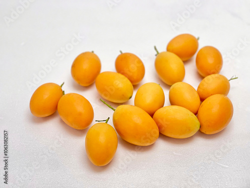 Sweet yellow marian plum isolated on white background. photo