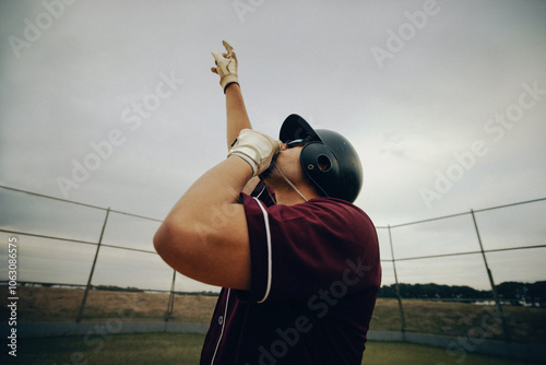 Baseball player kissing necklace as part of a superstition ritual on the field
