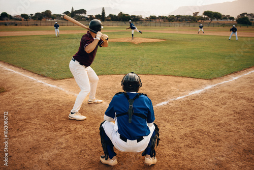 Baseball game in action with pitcher, batter, and catcher on a sunny day at the field photo