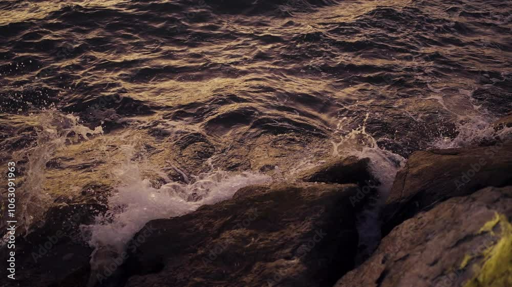 Soft dusk light on waves washing over rocks in slow motion, creating a calm, reflective seascape scene Soft dusk light on waves washing over rocks in slow motion, creating a calm, reflective seascape scene