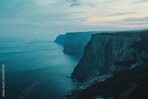 A breathtaking view of massive cliffs descending into the vast ocean, where the sky meets the water, creating a sense of awe and the immensity of nature’s wonders. photo