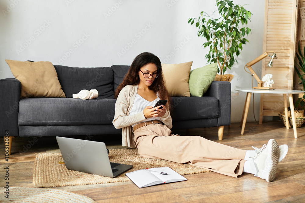 A woman sits comfortably on the floor, engaged with her mobile device in a serene space. A woman sits comfortably on the floor, engaged with her mobile device in a serene space.