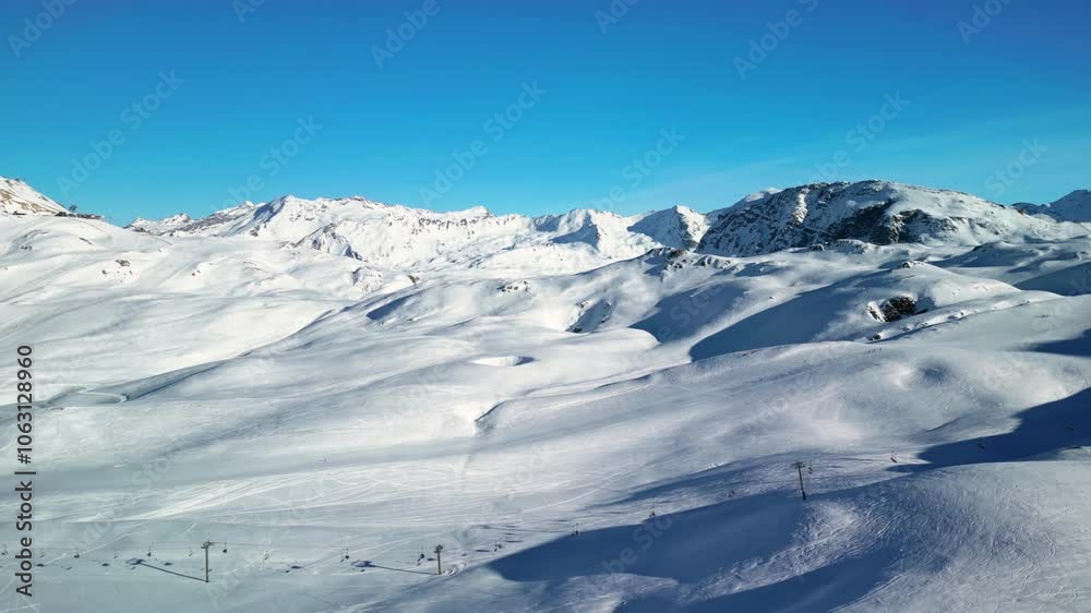 Val d'Isere, France: Aerial view of famous bustling ski resort in French Alps. Snow-covered slopes with ski runs, sunny day with clear blue sky - landscape panorama of Europe from above
Val d'Isere, France: Aerial view of famous bustling ski resort in French Alps. Snow-covered slopes with ski runs, sunny day with clear blue sky - landscape panorama of Europe from above