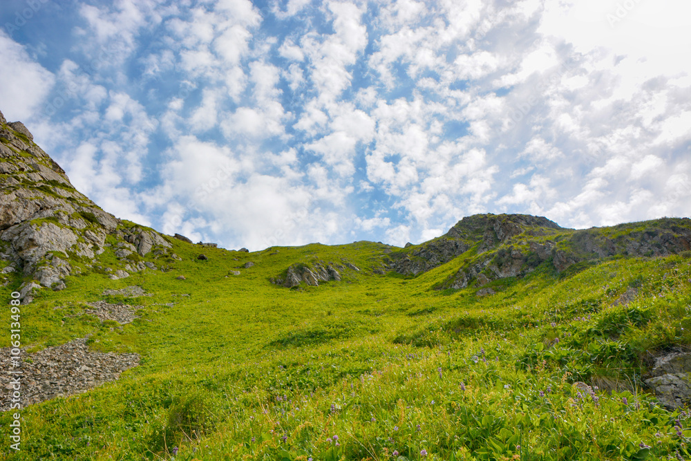 Idyllic summer landscape with hiking trail in the mountains with beautiful fresh green mountain pastures and clouds. Idyllic summer landscape with hiking trail in the mountains with beautiful fresh green mountain pastures and clouds.