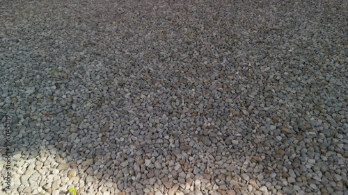 Close-up of gravel texture, showcasing diverse stones and natural elements. Ideal for backgrounds and nature-related projects.