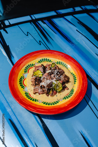 Roast beef with tonnato sauce served with cucumber on Colorful Plate photo