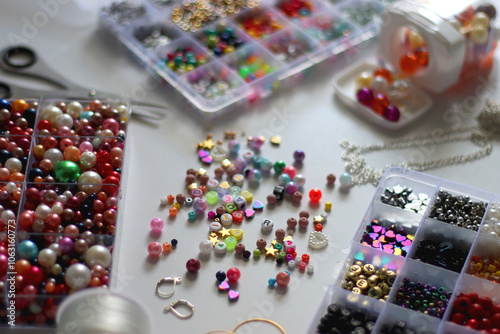 Obraz na płótnie Colorful beads, letter beads, threads and other jewelry making supplies on white background. Making friendship bracelets concept. Selective focus. w salonie
