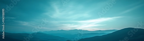 Silhouetted Mountain Range Under a Pale Blue Sky