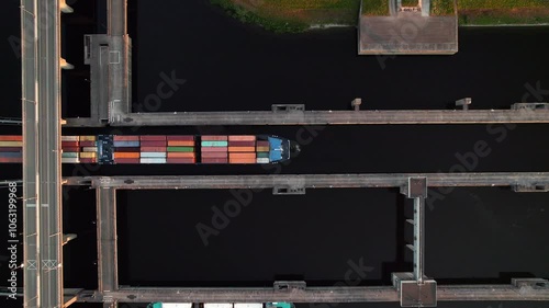 Container Ship Navigating Through Krammer Locks At Philipsdam In Bruinisse, Netherlands. aerial topdown shot photo