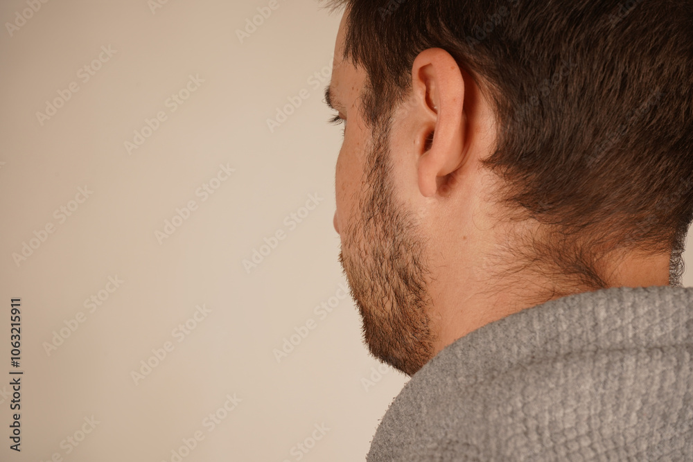 Neutral background. Male in casual clothes. Young guy standing in front of camera. Man looking at side. Head from back side. Side view. Handsome man. Neutral background. Male in casual clothes. Young guy standing in front of camera. Man looking at side. Head from back side. Side view. Handsome man.