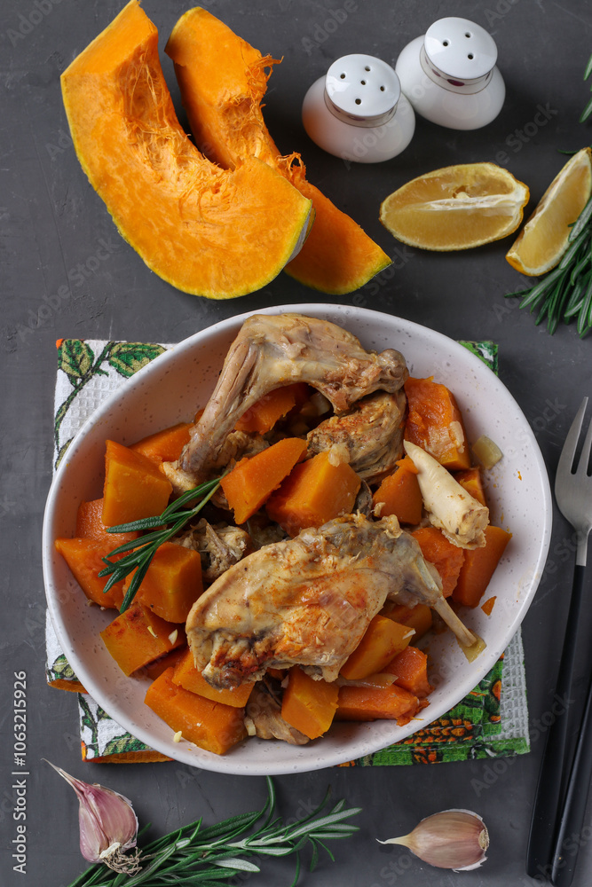 Rabbit meat with pumpkin and garlic in light plate Rabbit meat with pumpkin and garlic in light plate