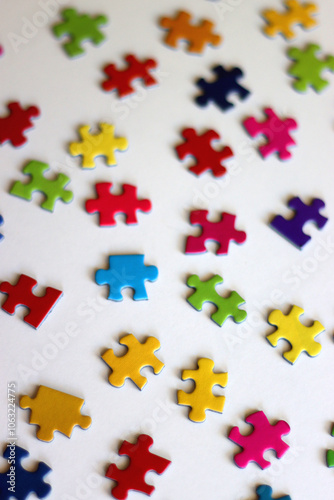 Colorful jigsaw puzzle pieces on white background. Selective focus.