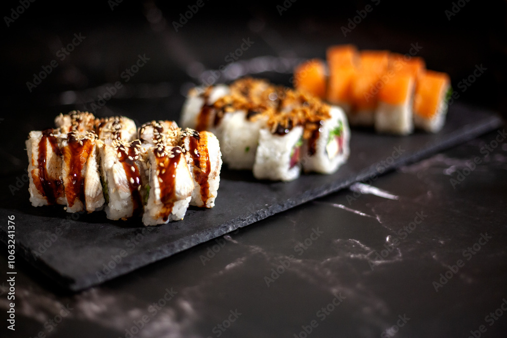 Eel sushi set. On a black background. With selective focus Eel sushi set. On a black background. With selective focus