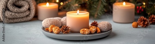 A serene arrangement of candles and decorative items on a textured surface, creating a cozy and inviting atmosphere.