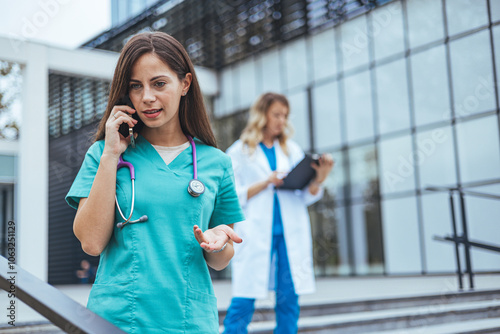 Medical Professionals Collaborating Outside Hospital Building photo