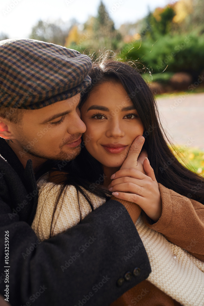 A couple shares a tender moment in autumn, wrapped in warm clothes surrounded by colorful leaves. A couple shares a tender moment in autumn, wrapped in warm clothes surrounded by colorful leaves.