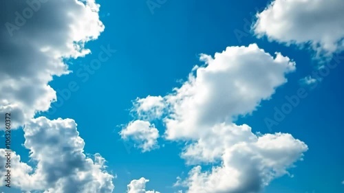 White clouds float in a blue sky on a bright day