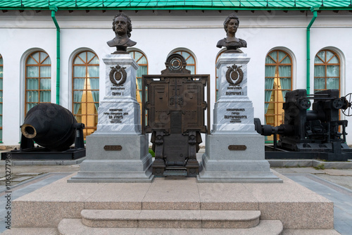 Bust of Emperor Peter the Great and Empress Catherine the Great near the Museum of Architecture and Design, surrounded by old equipment of metallurgical plants in the Urals. Ekaterinburg photo